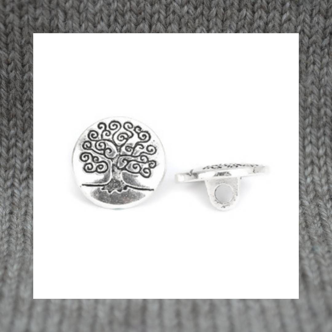 Zinc based alloy metal shank button in antique silver with a carved motif of the Tree of Life