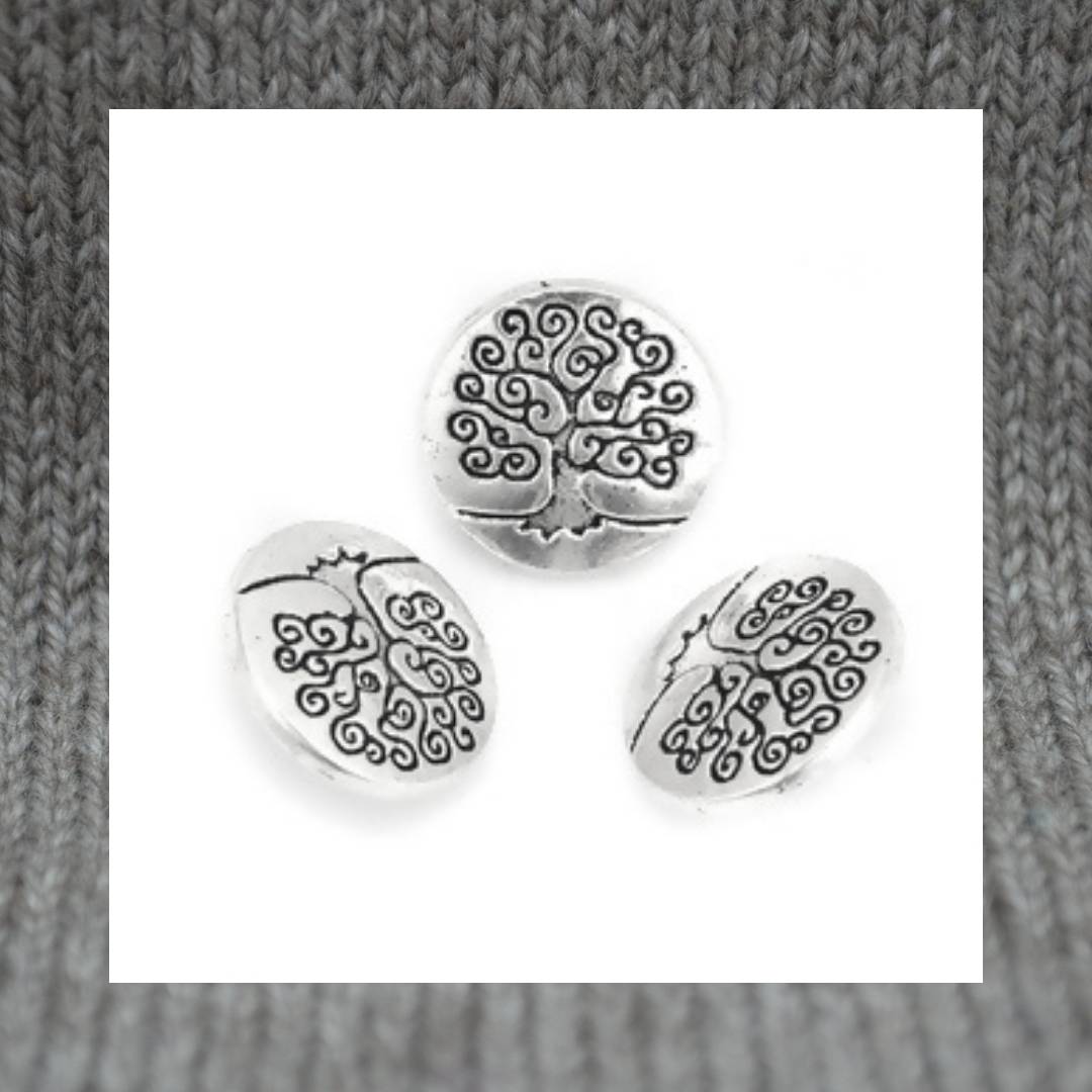 Zinc based alloy metal shank button in antique silver with a carved motif of the Tree of Life