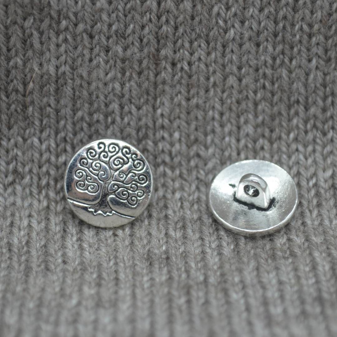 Zinc based alloy metal shank button in antique silver with a carved motif of the Tree of Life