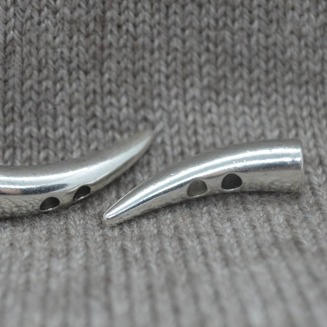 Two hole horn-shaped metal buttons in a zinc based alloy, antique silver, 30mm x 8mm 1 1/8" x 6/8"